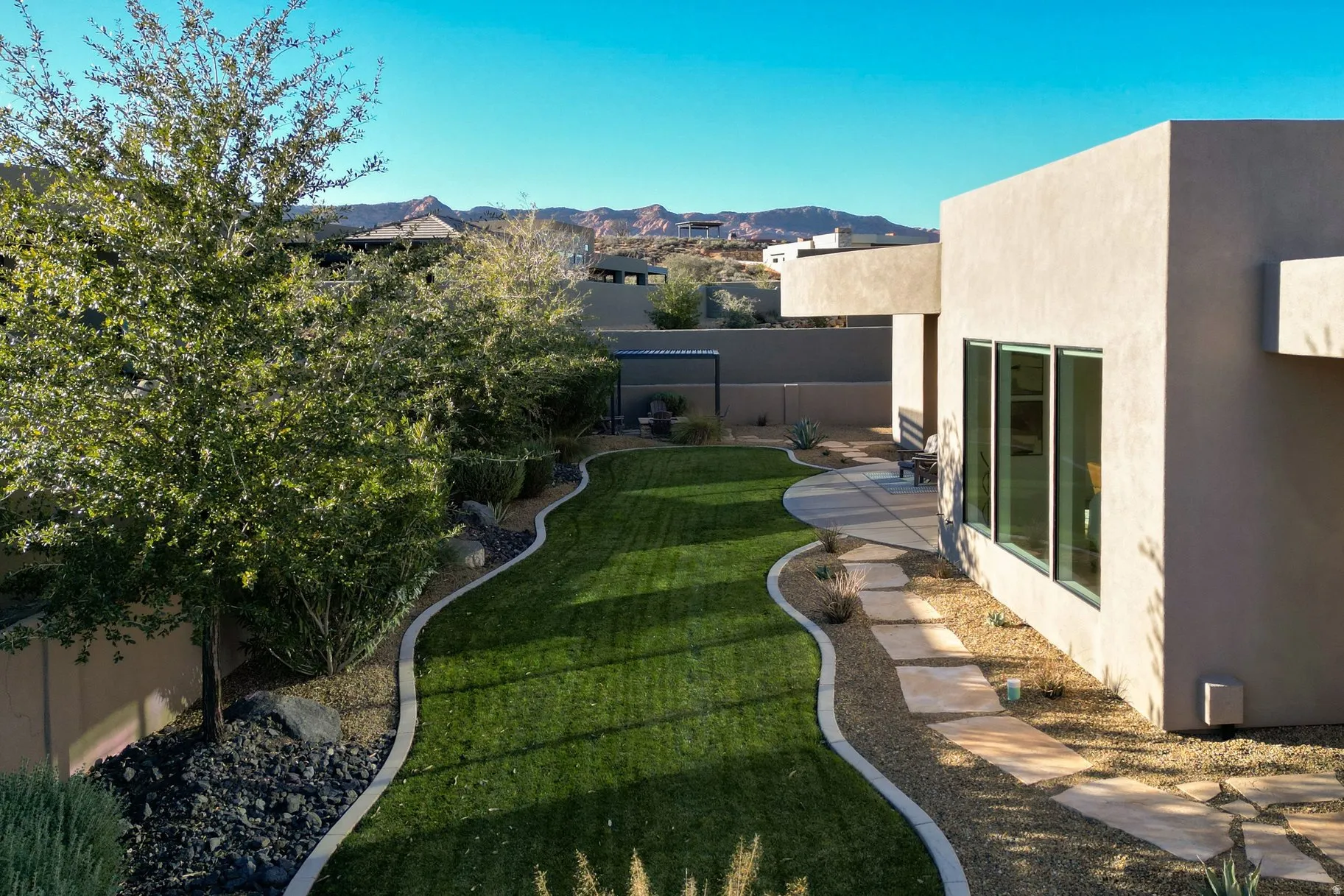 Fenced backyard featuring a mountain view