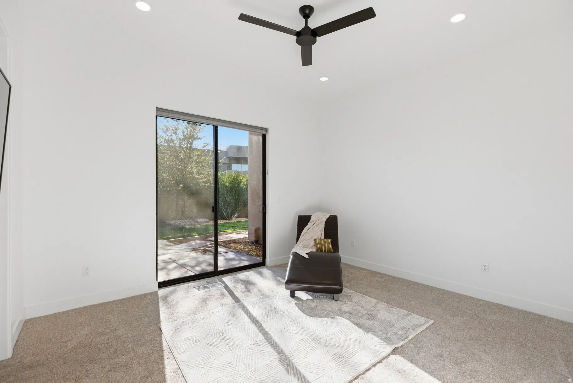Unfurnished room featuring light colored carpet, a ceiling fan, and recessed lighting