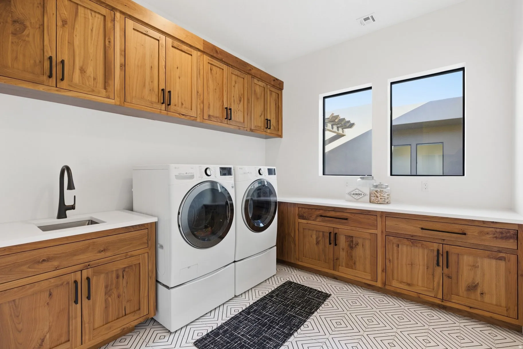 Laundry area featuring cabinet space, separate washer and dryer, and light flooring