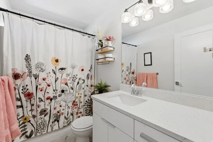 Bathroom featuring vanity and curtained shower