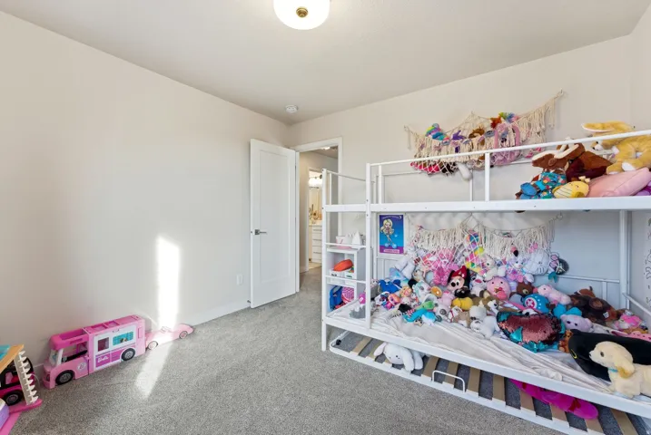 Bedroom with carpet flooring and baseboards