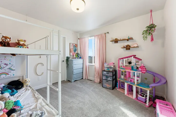 Bedroom featuring carpet flooring and baseboards