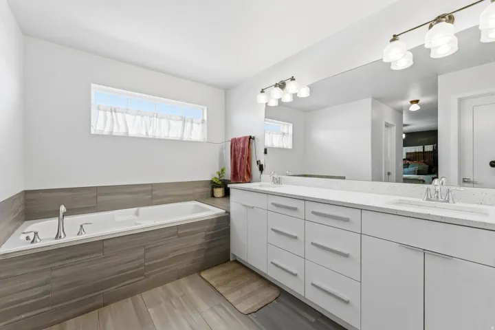 Ensuite bathroom with double vanity and a garden tub
