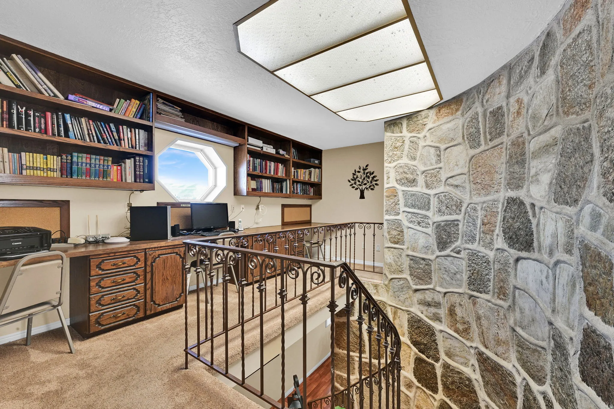Office space with light colored carpet and built in desk