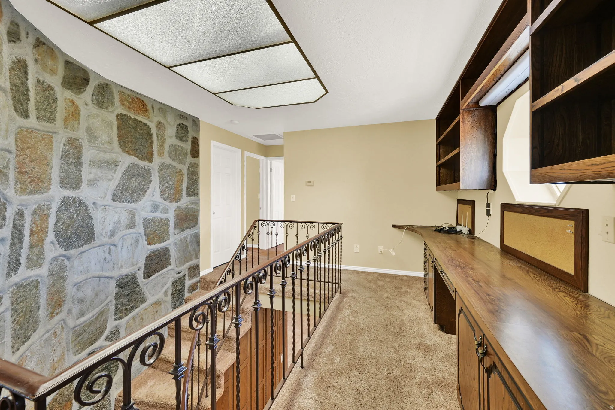 Upstairs Spiral Staircase Hallway featuring an upstairs landing with Office Study Space 2nd and 3rd Bedroom at End of Hall