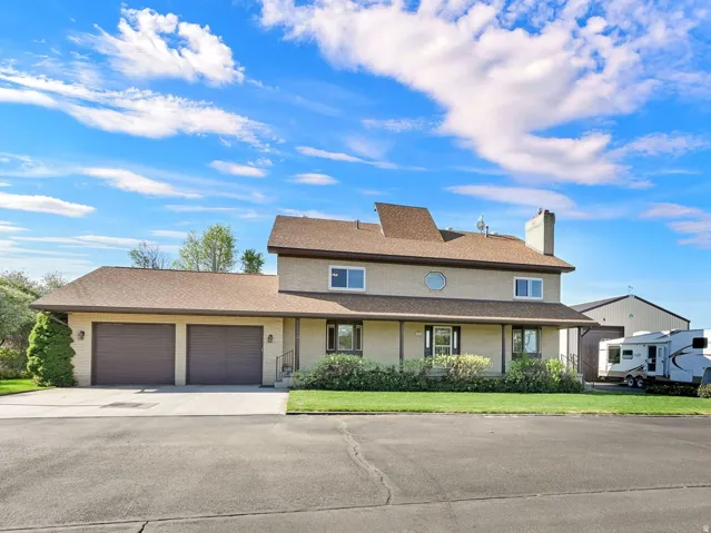 View of front of home featuring a garage, a chimney, a front lawn, and driveway with Trailer RV Toy Parking