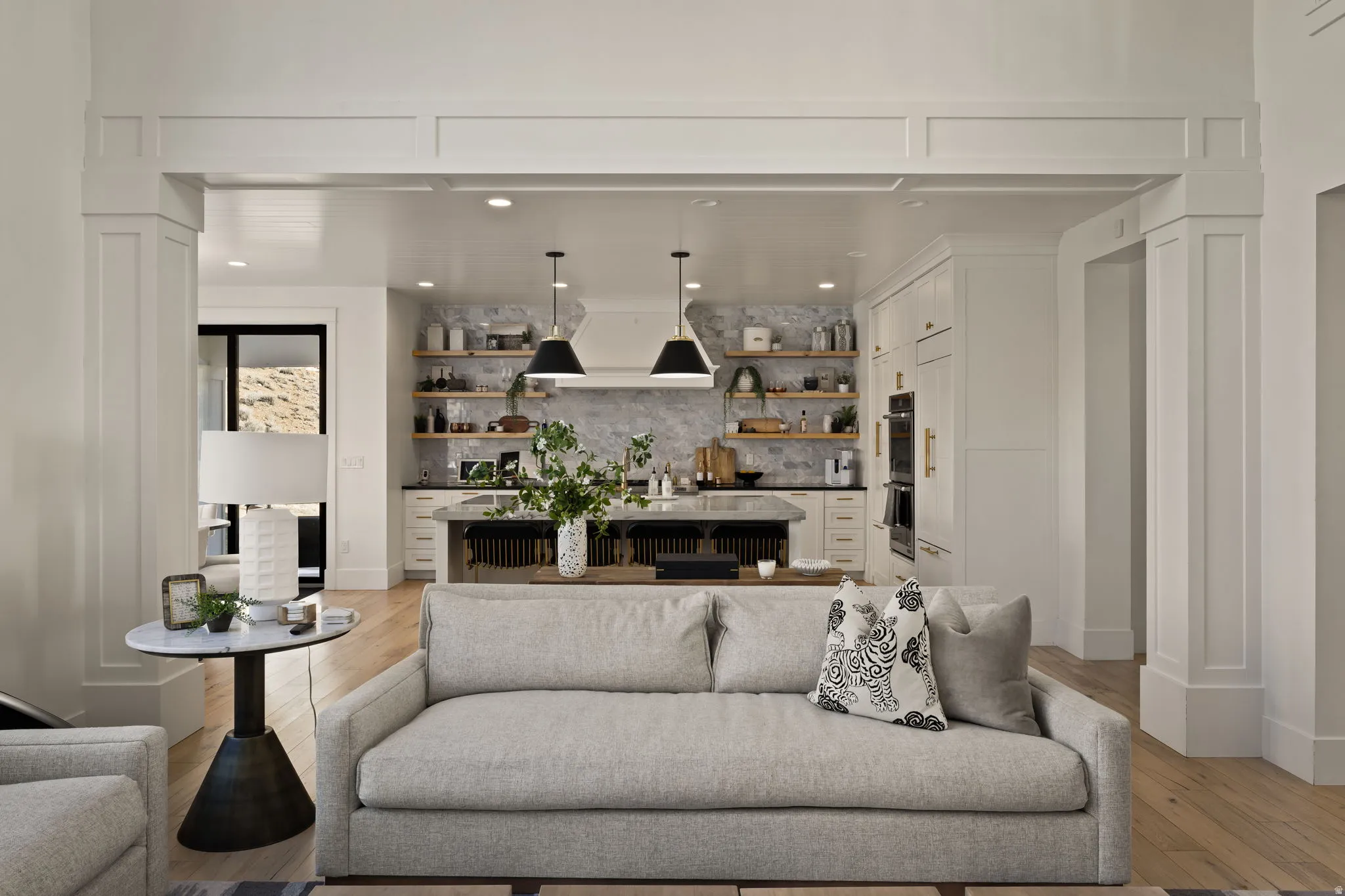 Living area with light wood-type flooring and recessed lighting