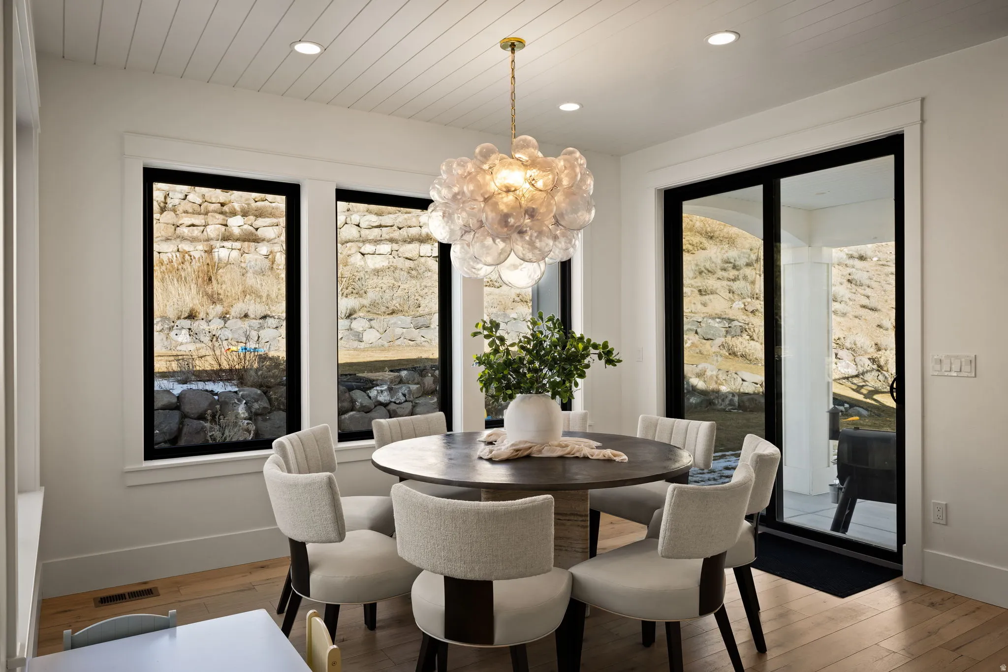 Dining area with a chandelier, light wood-type flooring, recessed lighting, and wooden ceiling