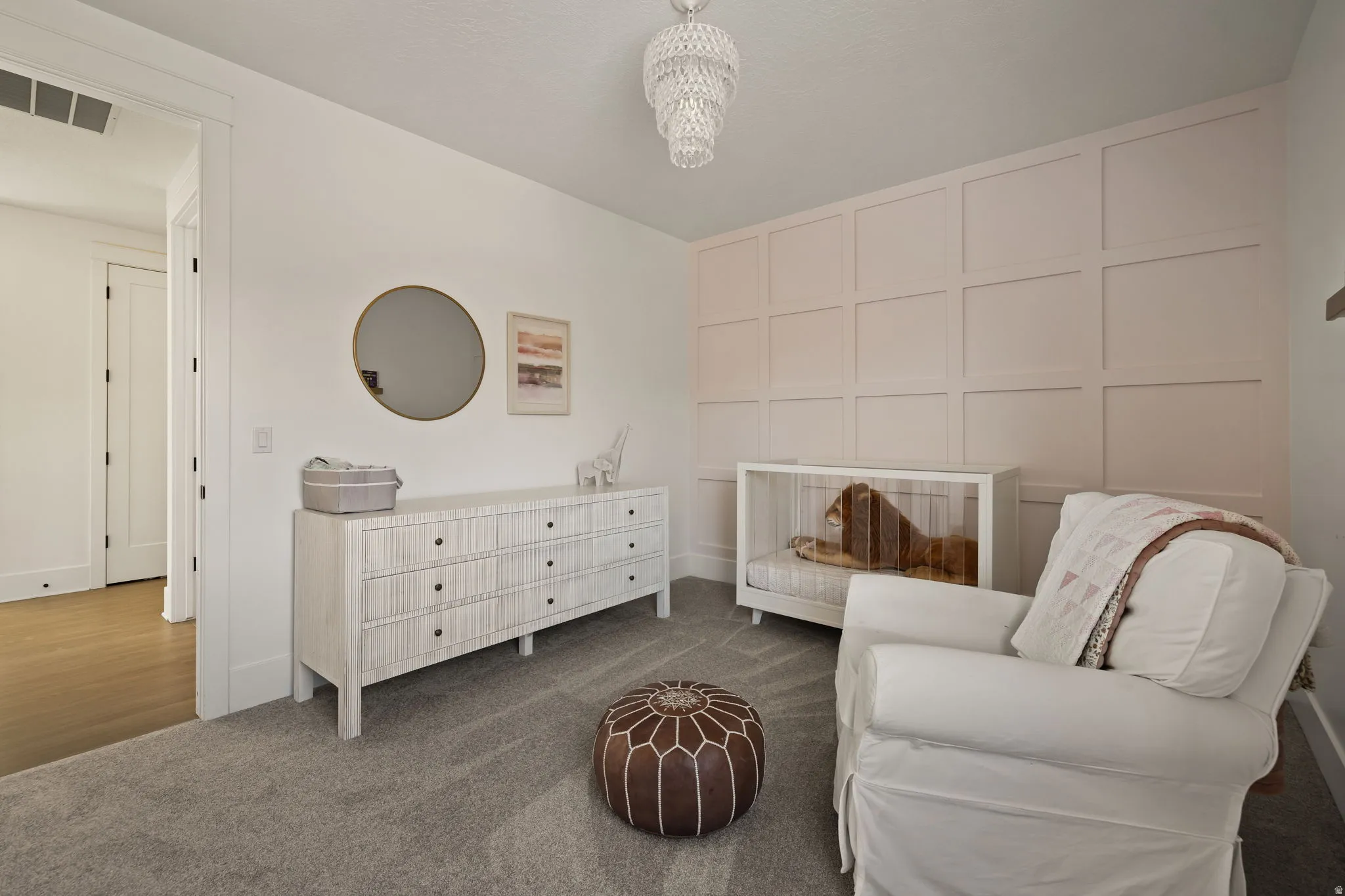 Sitting room featuring carpet and a decorative wall