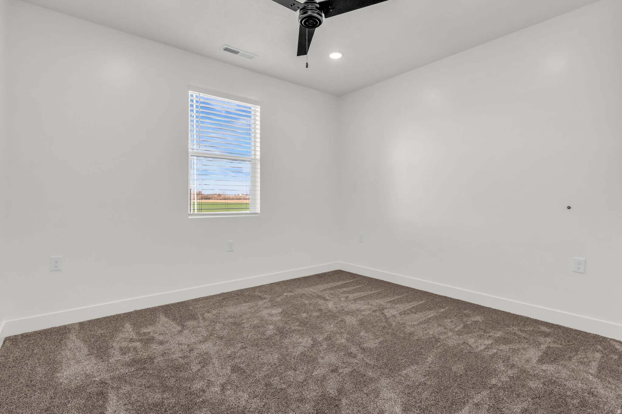 Unfurnished room with dark carpet, a ceiling fan, and recessed lighting