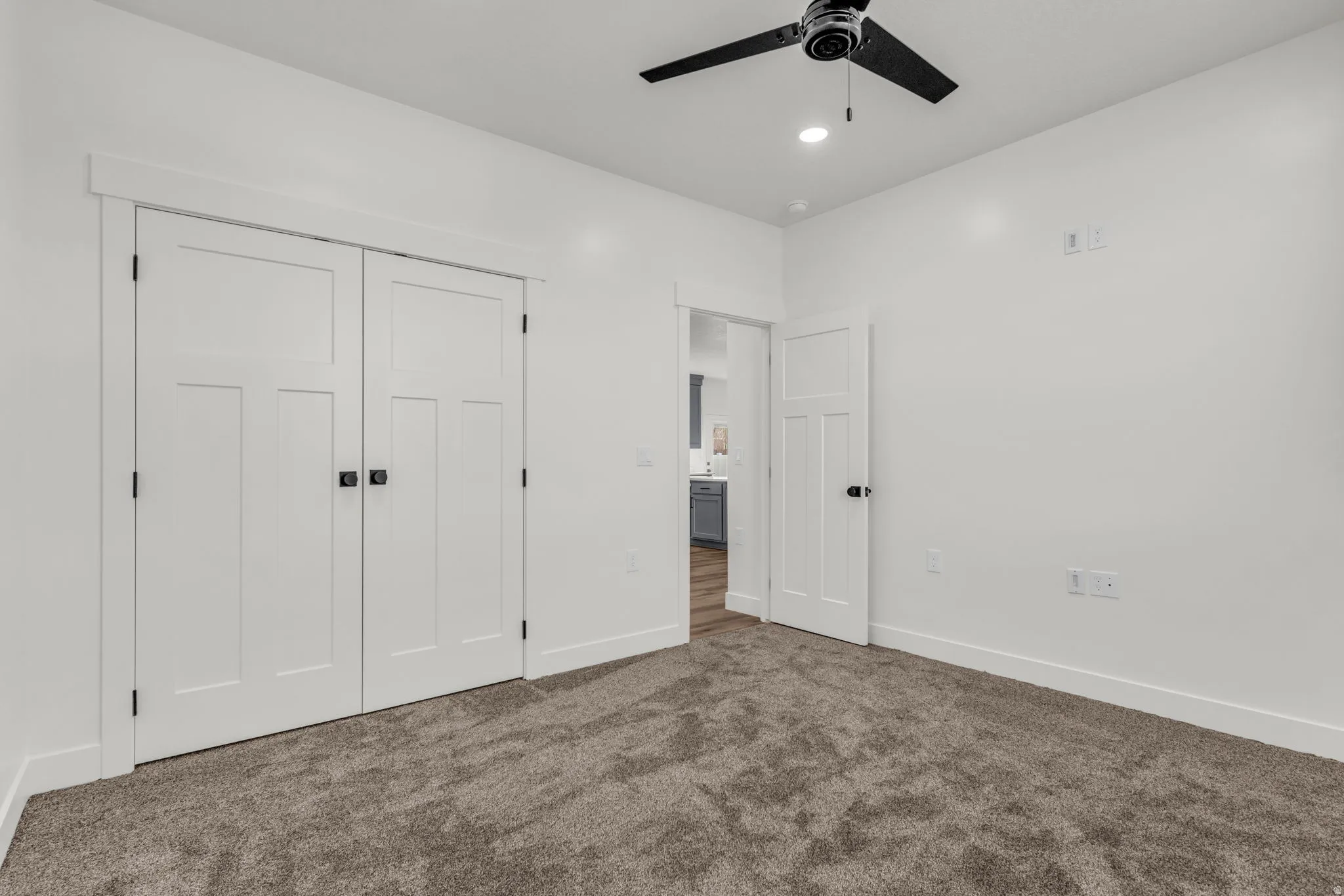 Unfurnished bedroom with dark carpet, a closet, ceiling fan, and recessed lighting
