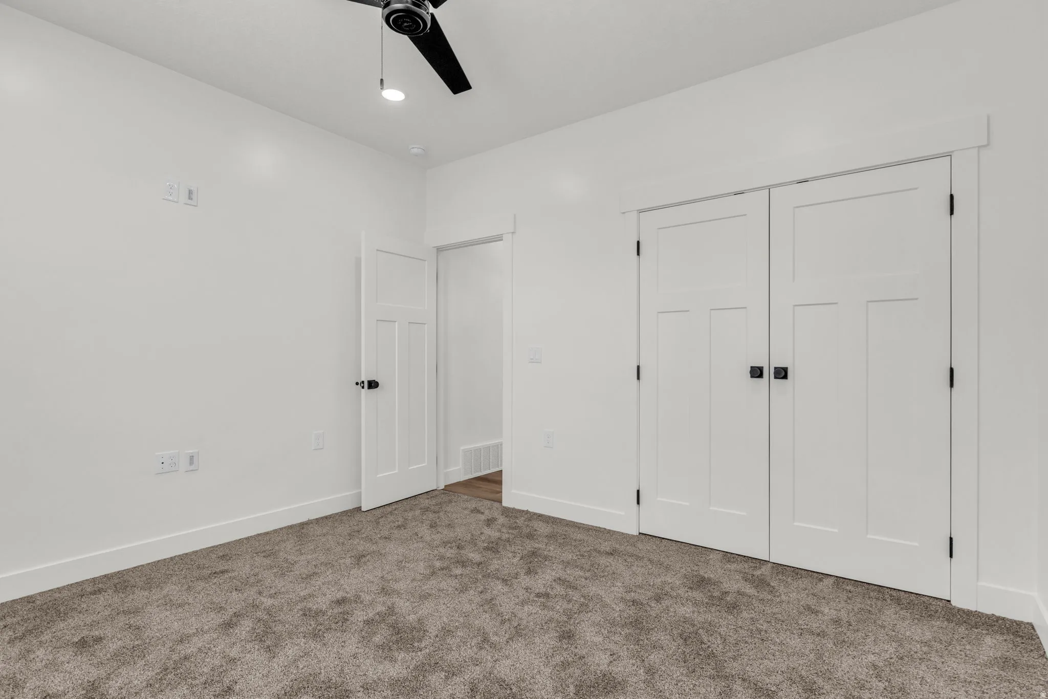 Unfurnished bedroom featuring carpet flooring, a closet, and ceiling fan
