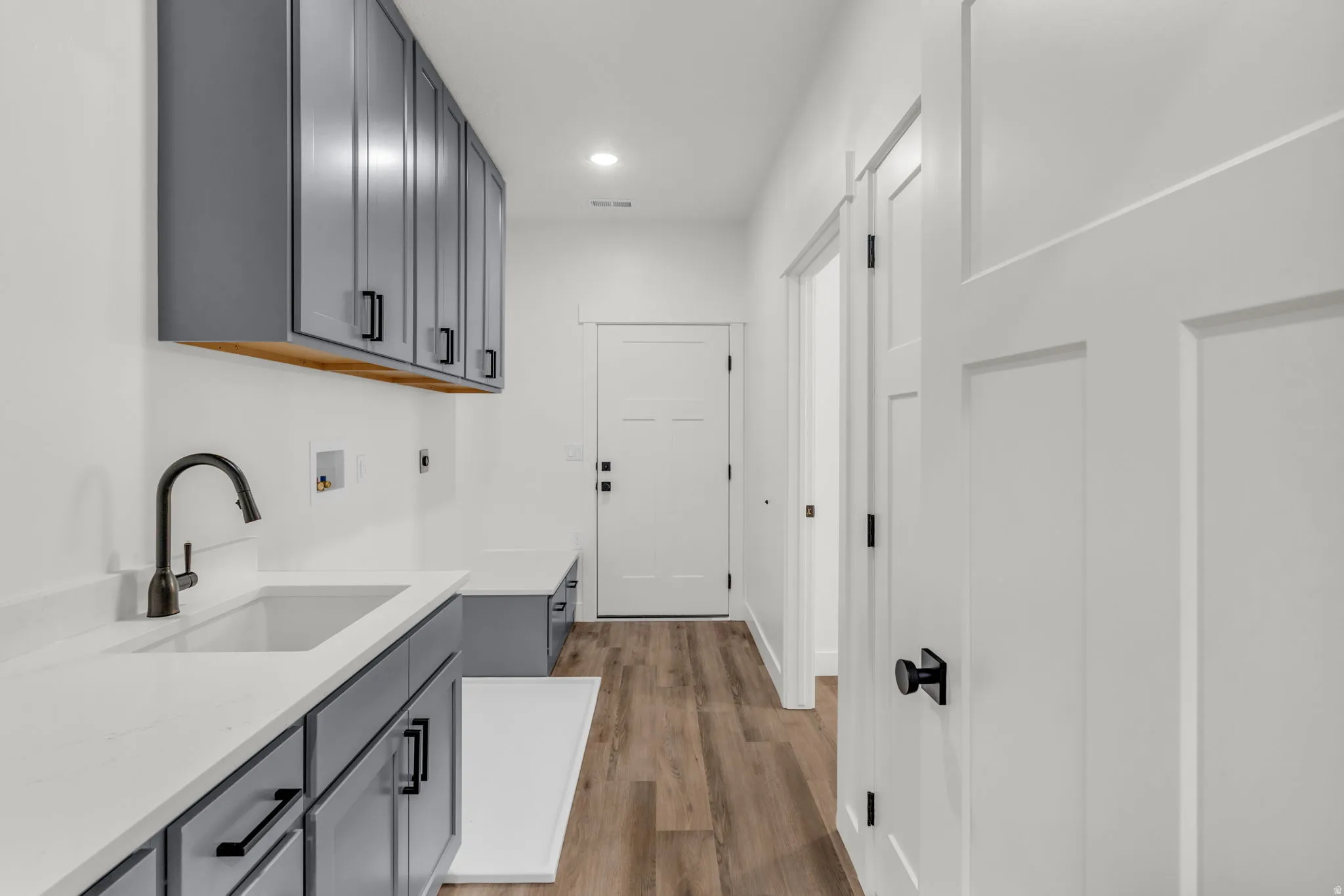 Laundry room with hookup for a washing machine, cabinet space, recessed lighting, dark wood-style floors, and electric dryer hookup