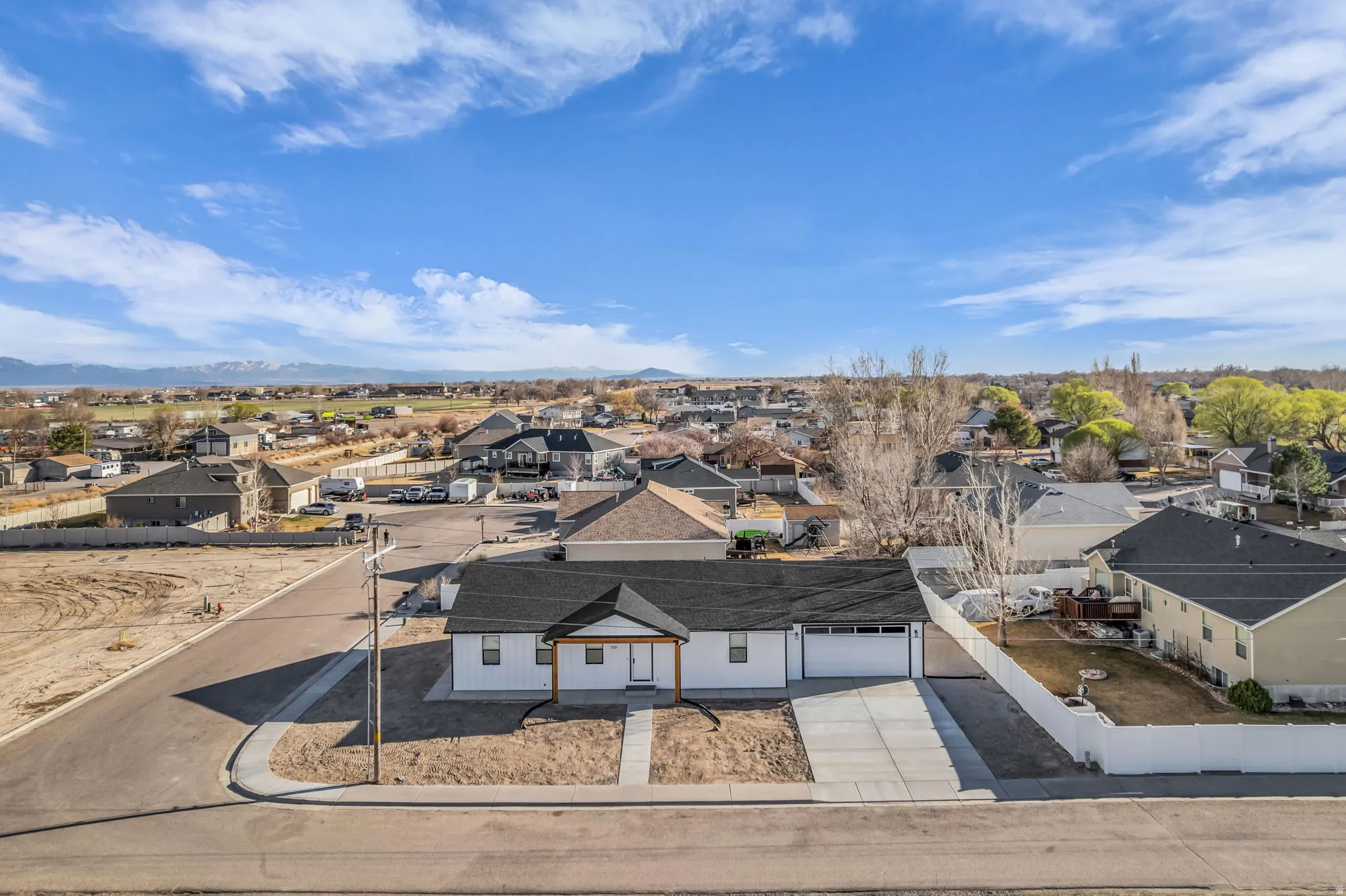Aerial perspective of suburban area featuring a mountain backdrop