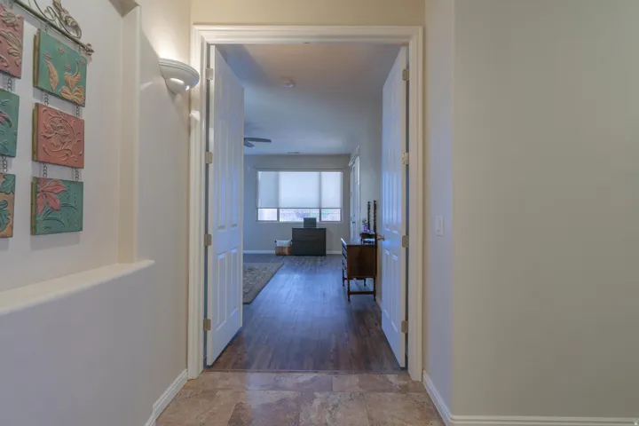 Hallway featuring baseboards and stone finish flooring