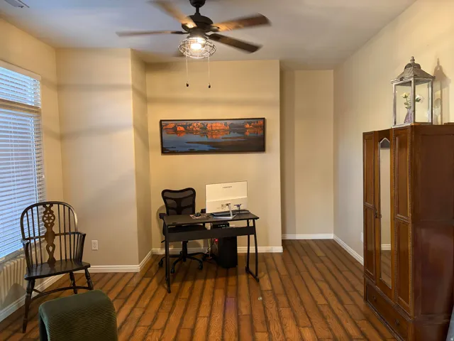 Office with a ceiling fan and dark wood finished floors