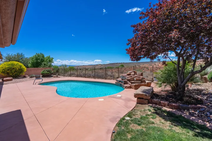 View of swimming pool with a fenced backyard and a patio