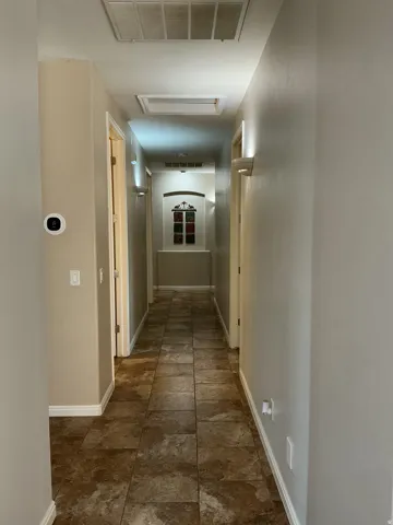 Corridor featuring baseboards