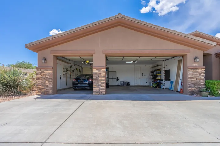Garage featuring concrete driveway
