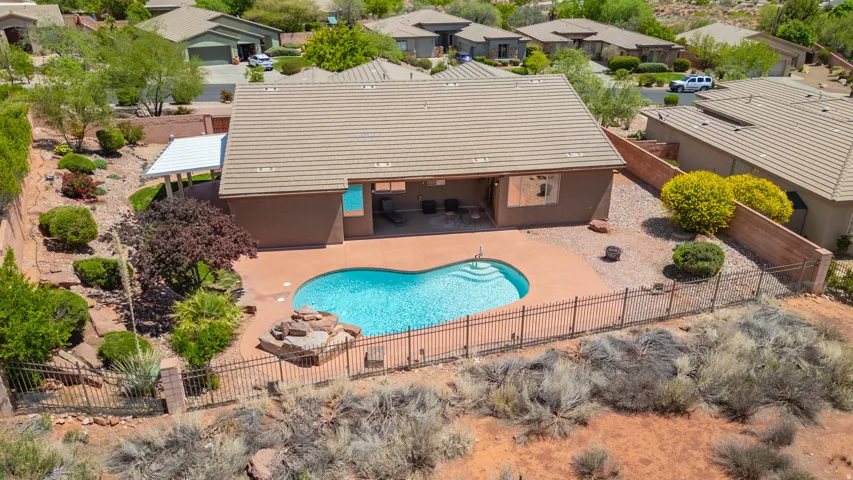 View of swimming pool with a fenced backyard, a patio area, and a residential view