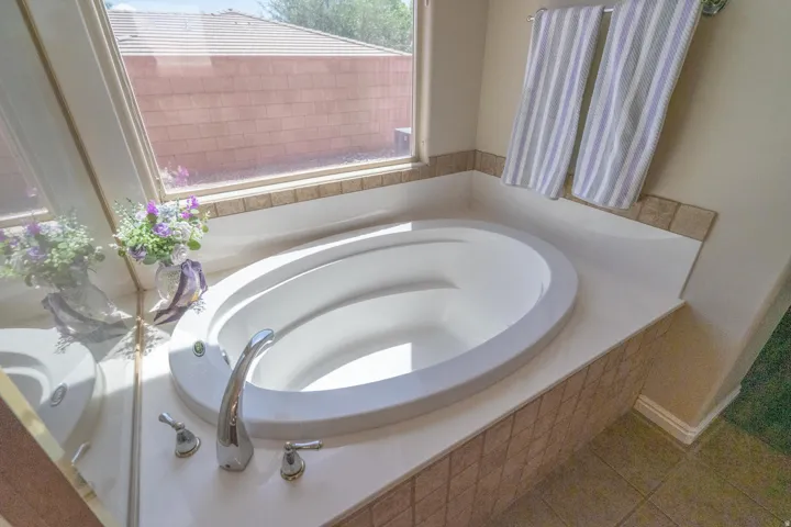 Bathroom with a bath and tile patterned floors