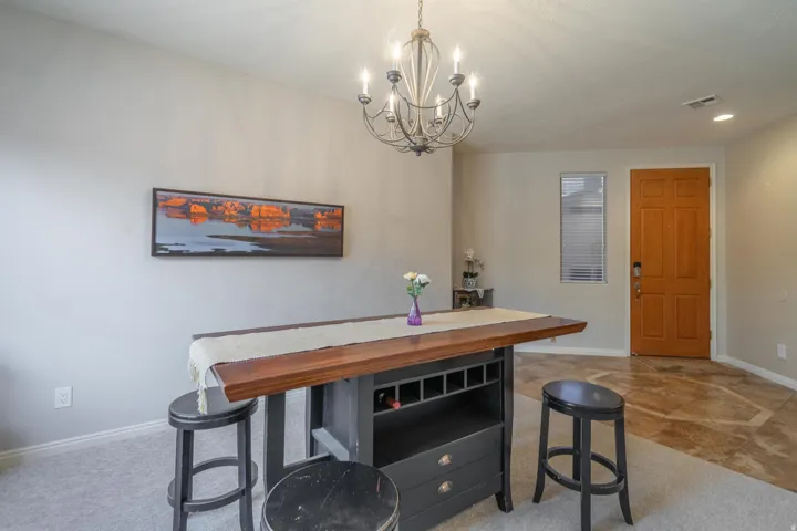Dining area featuring light carpet, recessed lighting, and a chandelier