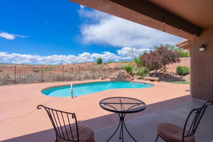 View of swimming pool with a fenced backyard and a patio area