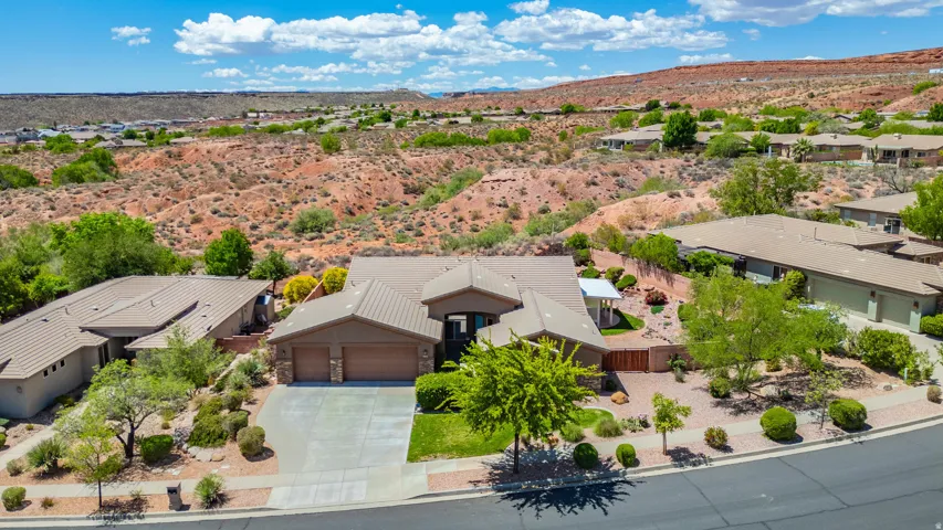 Aerial view of property and surrounding area with a mountainous background