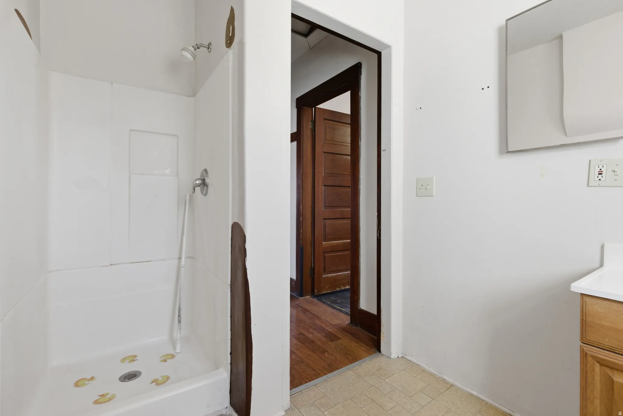 Bathroom with vanity and a shower stall