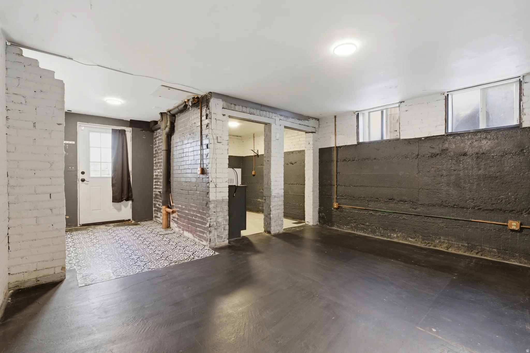 Below grade area with brick wall