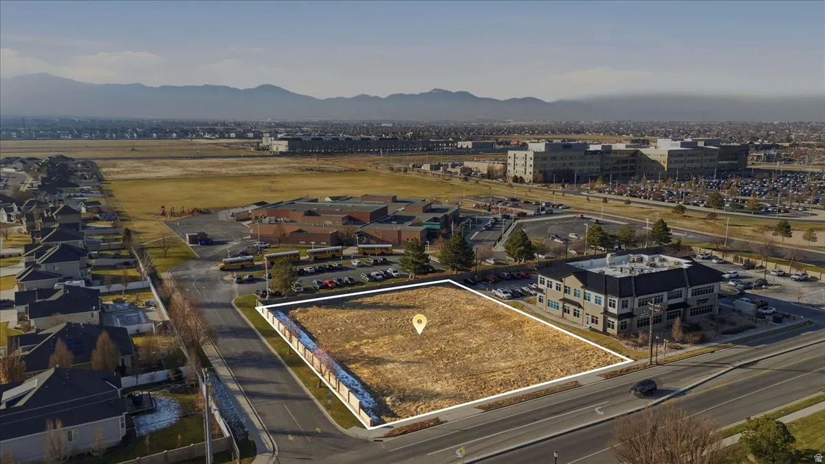Aerial overview of property's location featuring property parcel outlined and a mountain backdrop
