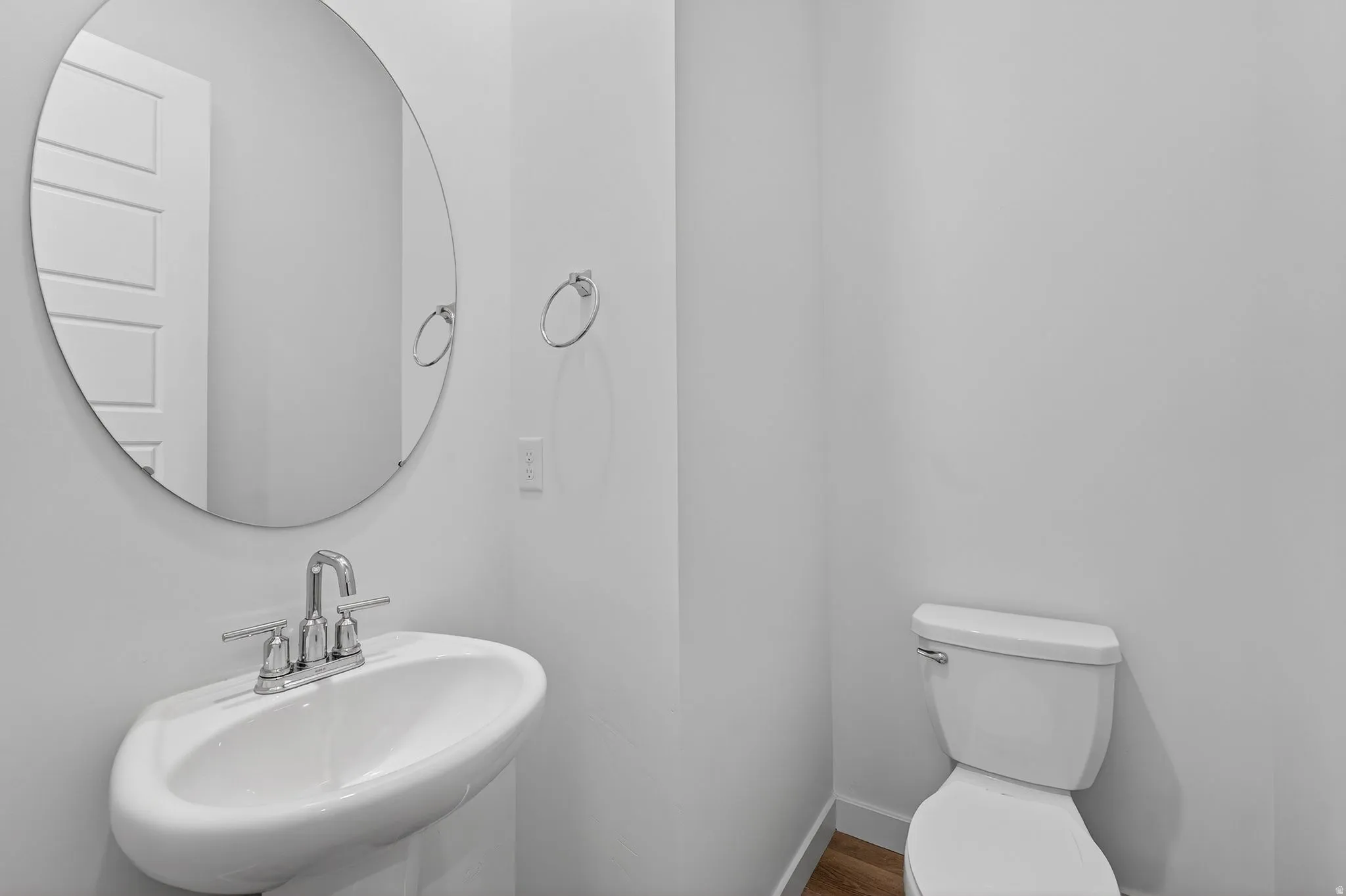 Half bathroom featuring a sink and toilet