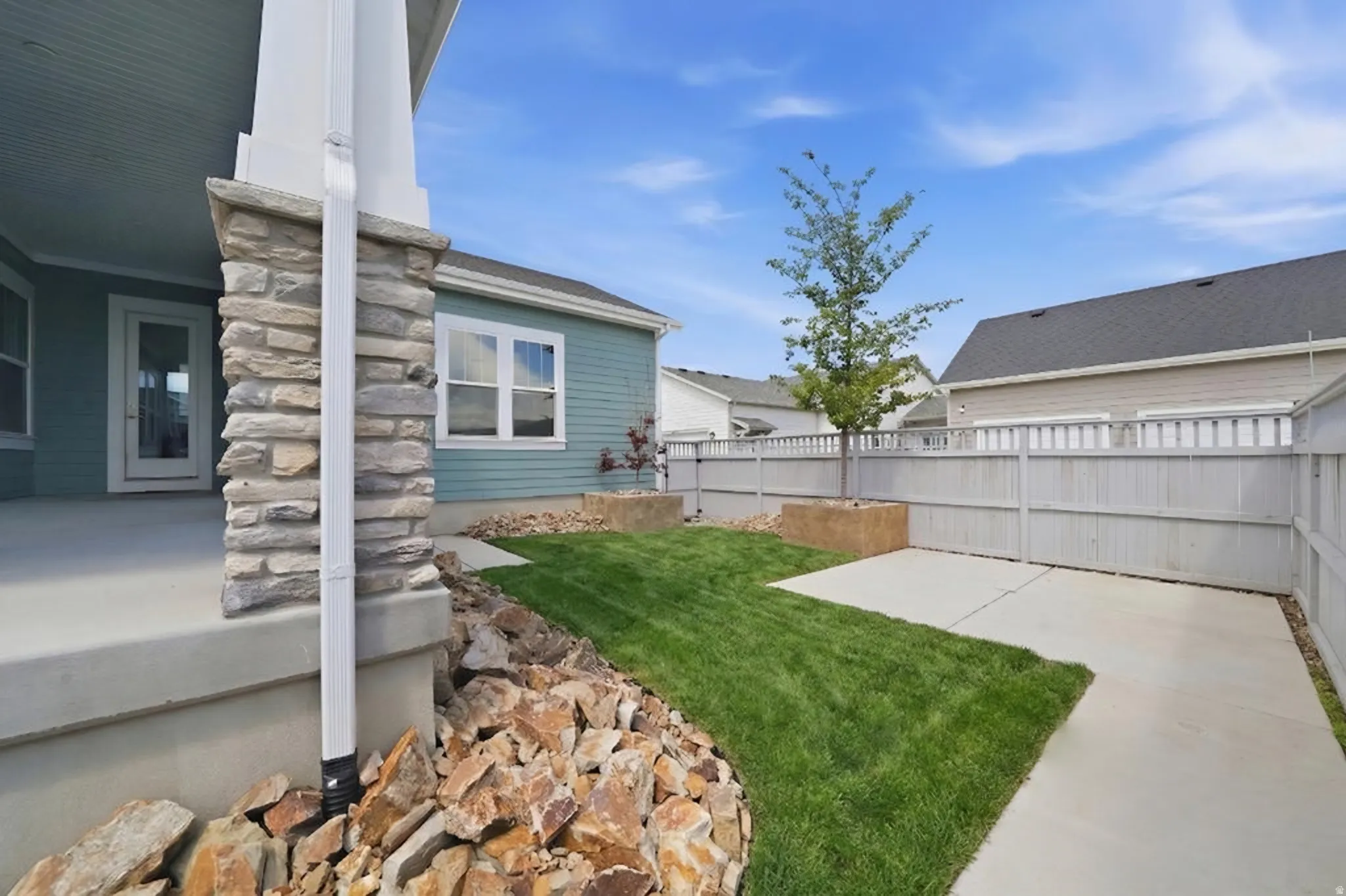 View of yard featuring a covered patio area (grass has been seeded and will be grown in within the next month this grass is virtual)