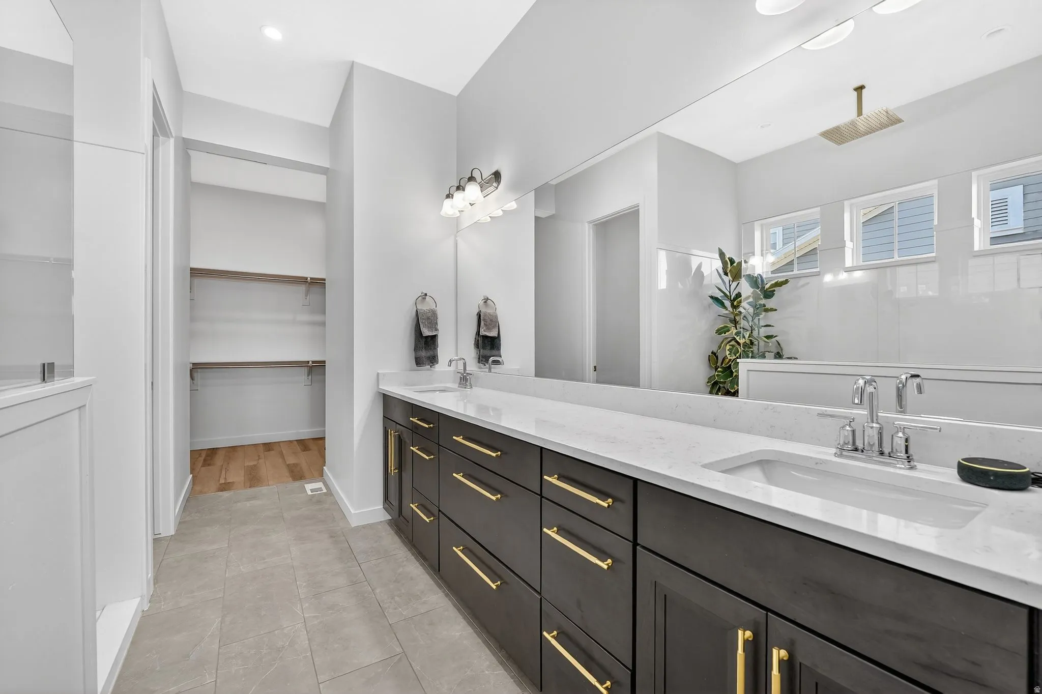 Owners full bath featuring double vanity, a spacious closet, and large walk in shower