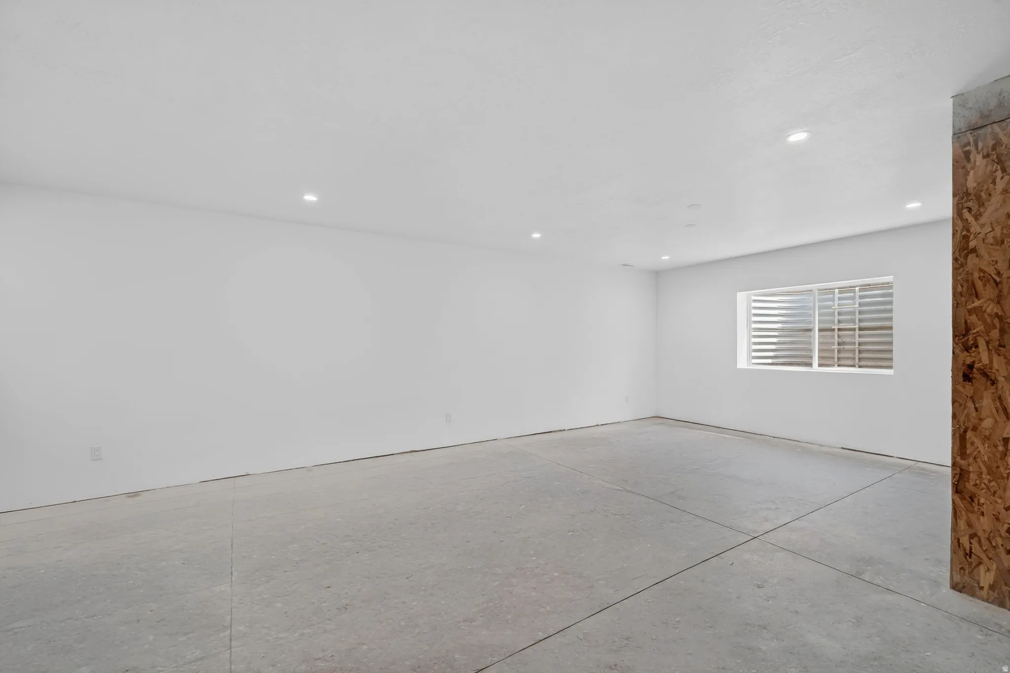 Spare room with concrete floors and recessed lighting