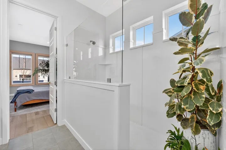 Owners full bath featuring double vanity, a spacious closet, and large walk in shower