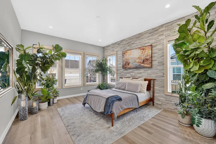 Owner's Suite with tons of natural light and beautiful upgraded accent stone wall