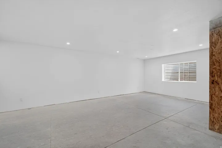 Spare room with concrete floors and recessed lighting