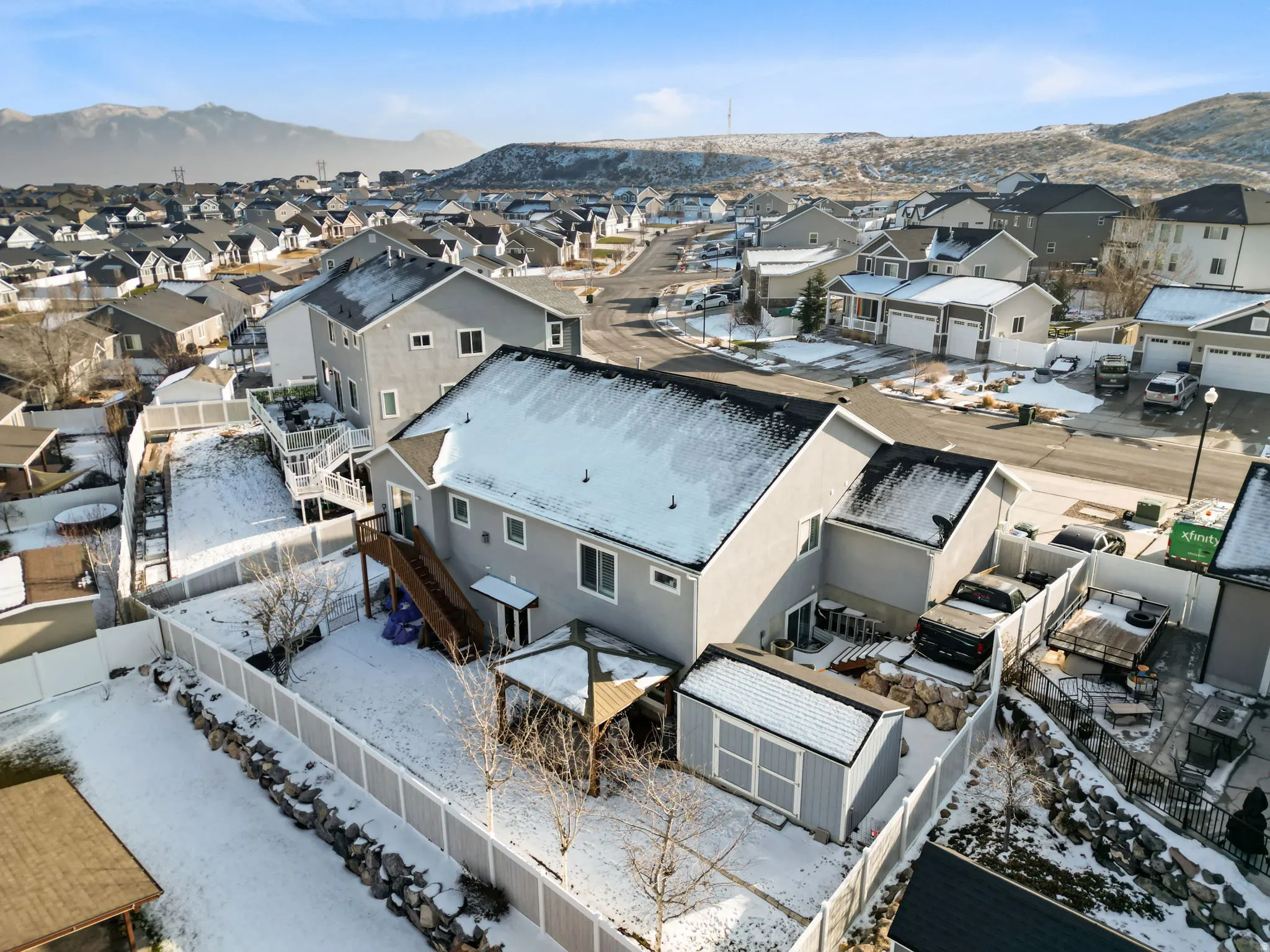 Snowy aerial view featuring a mountain view and a residential view