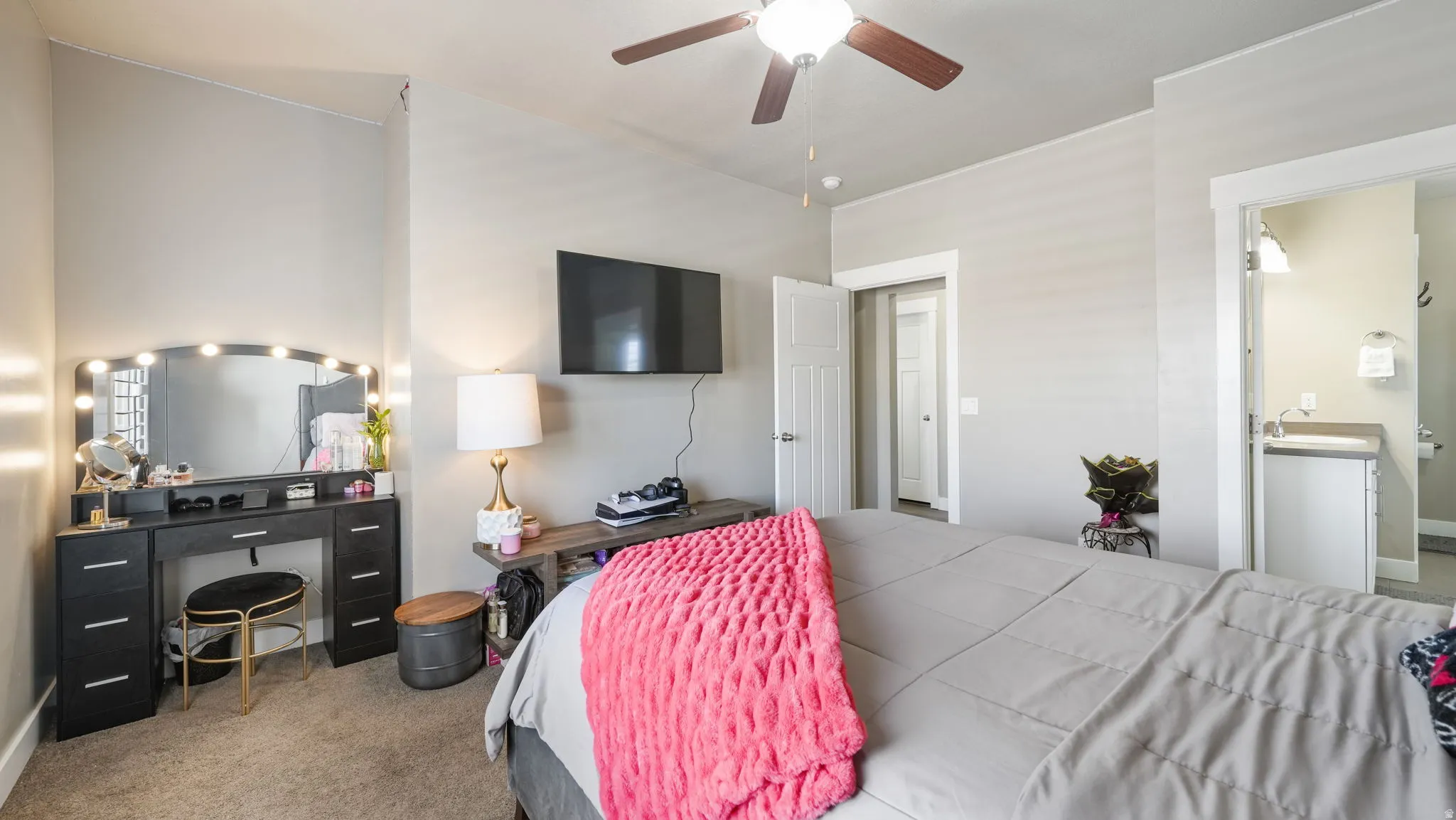 Bedroom featuring carpet, ceiling fan, and ensuite bathroom