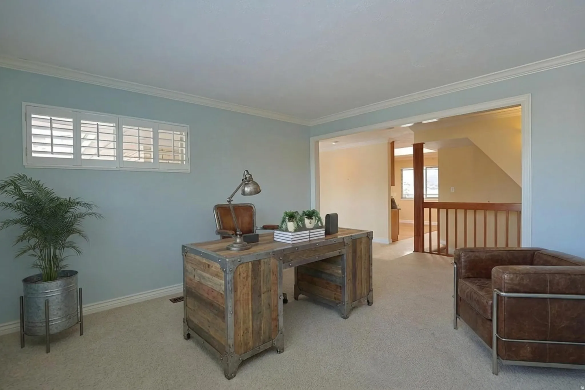 Office area with carpet flooring and ornamental molding