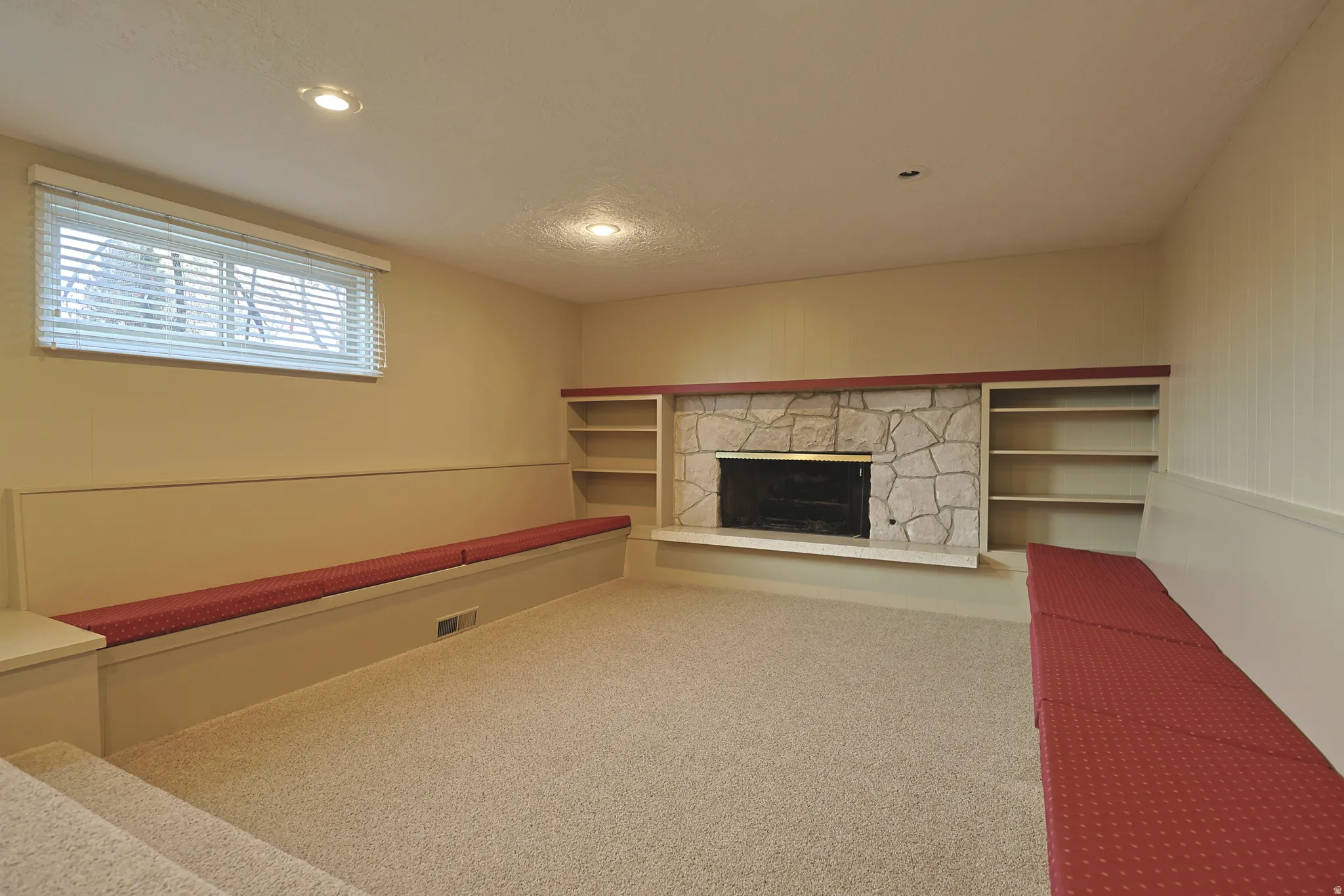Unfurnished living room featuring a fireplace, carpet, and recessed lighting
