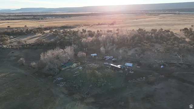 Aerial view of property and surrounding area with rural landscape and a mountain backdrop