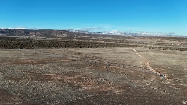 View of rural area featuring a desert landscape and a mountain backdrop