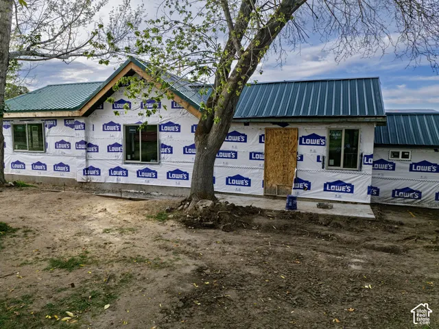 Newly installed metal roofing, multiple windows, and a foundation