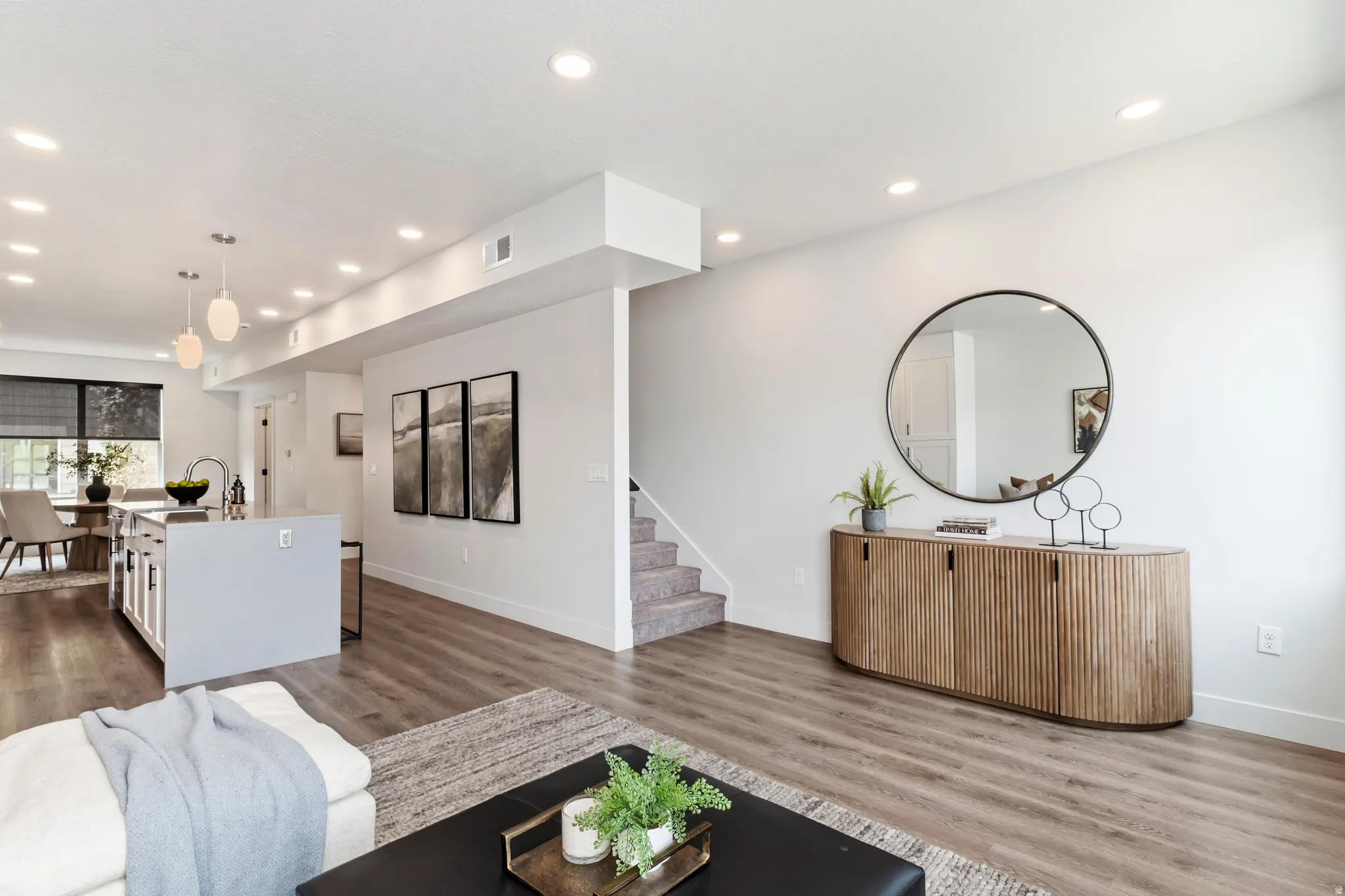 Living area featuring recessed lighting, dark wood-style flooring, and stairway Model Home