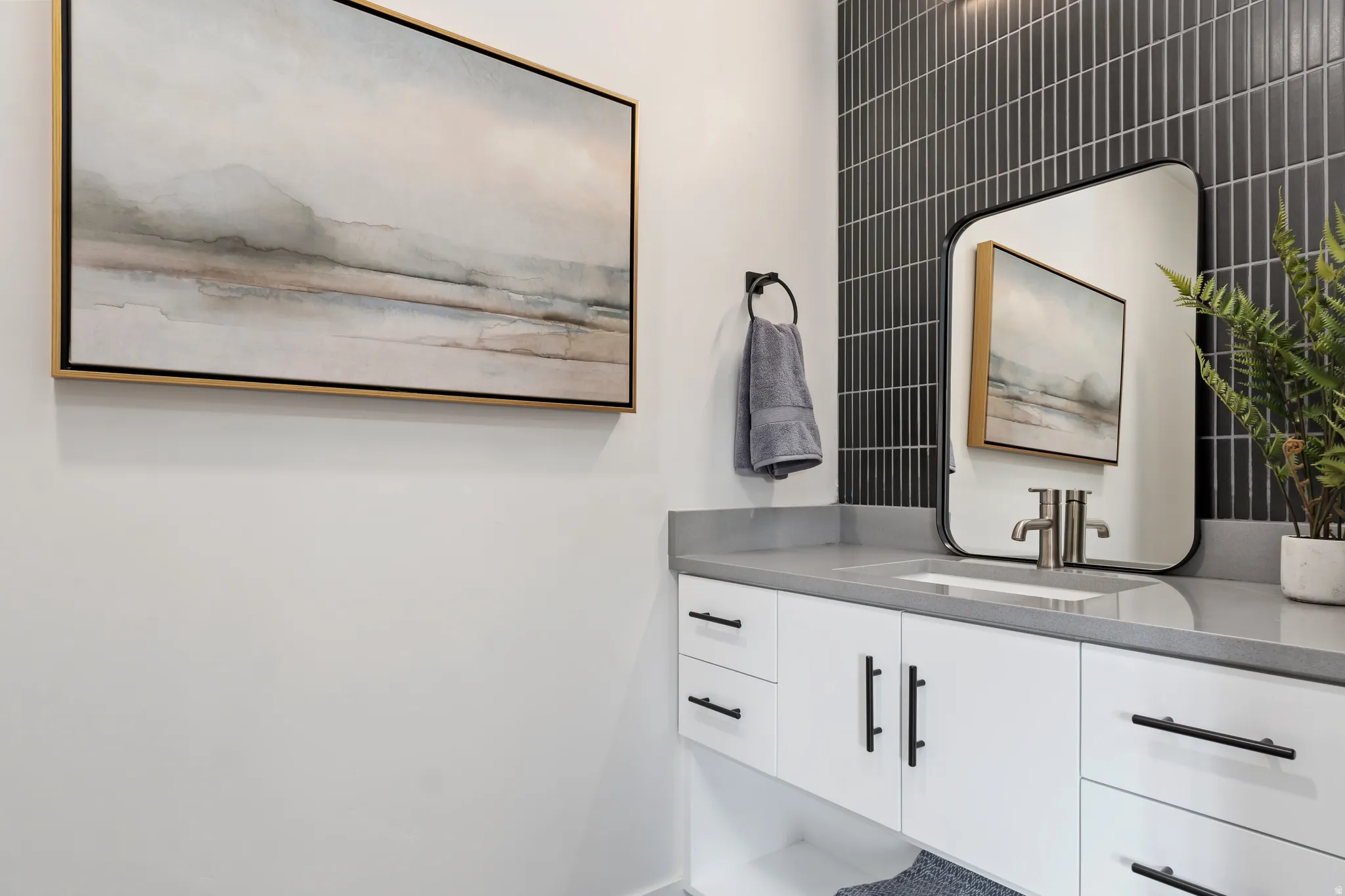 Half bathroom with vanity and baseboards. Model Home