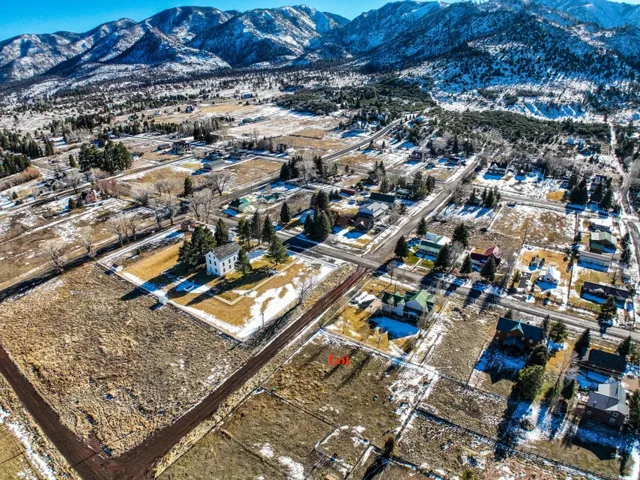 Snowy aerial view with a mountain view and a residential view