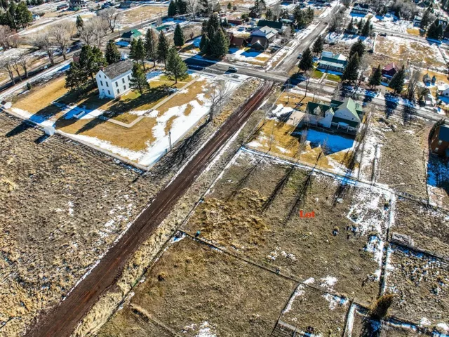 Aerial view of property and surrounding area with nearby suburban area