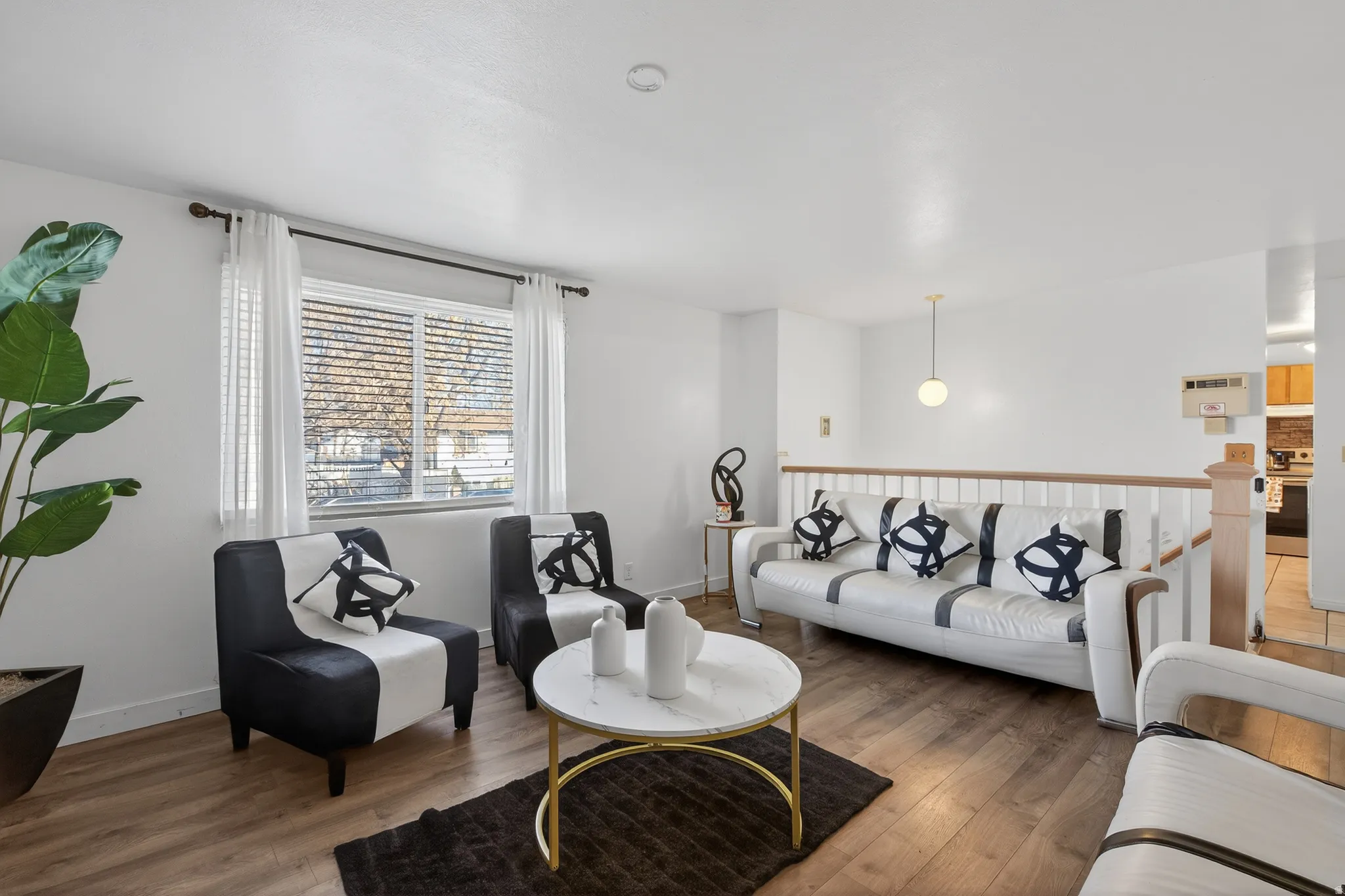 Living room featuring light wood-style flooring and baseboards